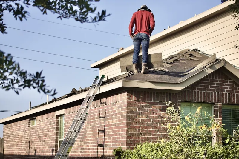 Professional roofer working on a residential roof in Vermilion